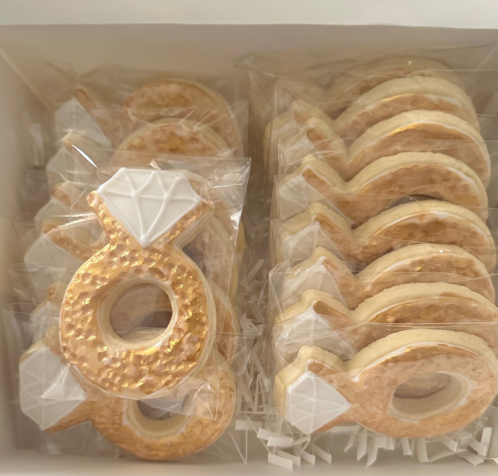 Individually wrapped engagement ring cookies with metallic gold icing