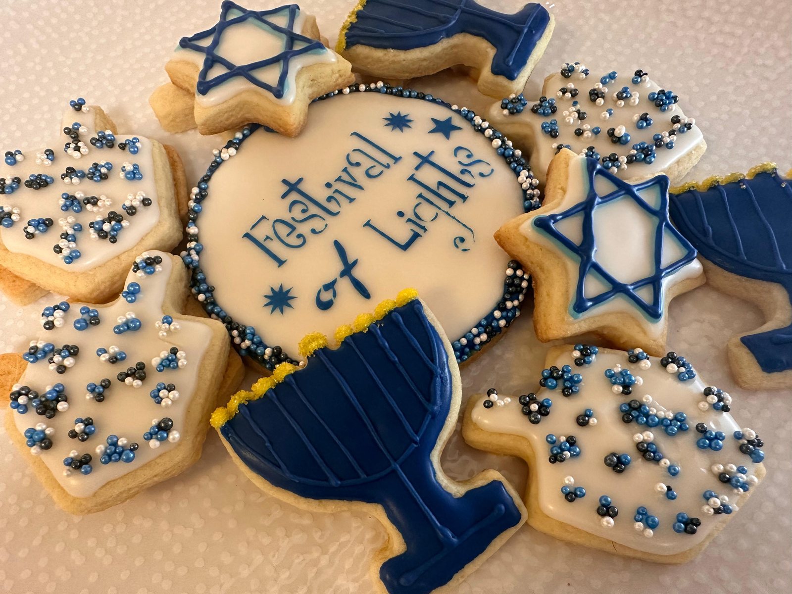 Blue and white Hanukkah decorated cookies with menorahs and Star of David designs