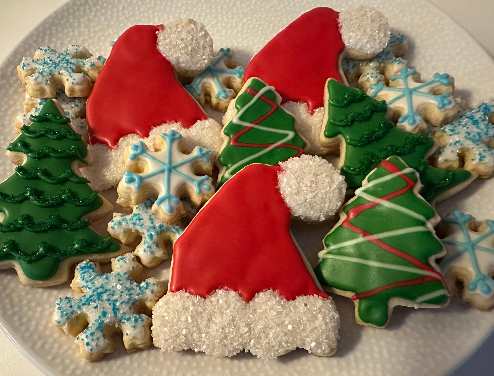 Christmas tree, Santa hat, and snowflake decorated holiday cookies